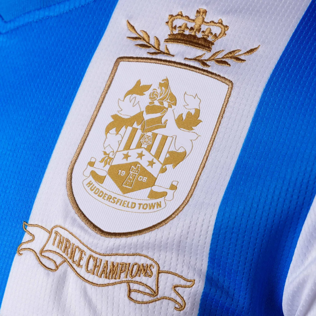 Huddersfield Town Thrice Champions crest and scroll detail