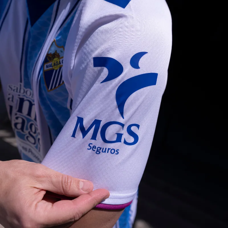 Málaga CF 2026-27 Muy Noble neckline inscription